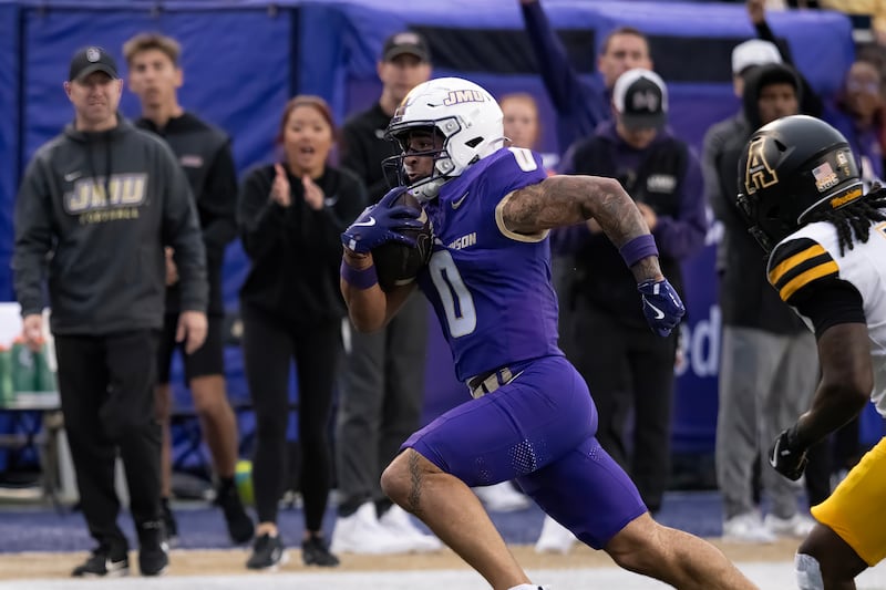 James Madison wide receiver Jaylan Sanchez running towards the endzone during a football game...