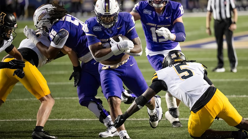 James Madison running back Jobi Malary running through a defender during a football game...