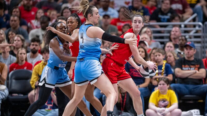Indiana Fever guard Caitlin Clark, right, looks to pass as Chicago Sky guard Marina Mabrey (4)...