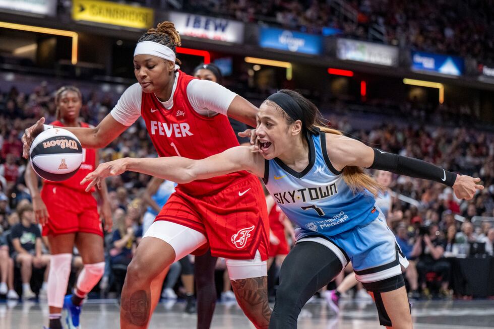 Indiana Fever forward NaLyssa Smith (1) and Chicago Sky guard Chennedy Carter (7) reach for...