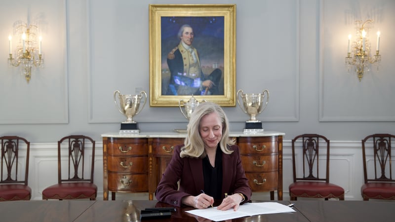 Governor Abigail Spanberger signs a bill into law.