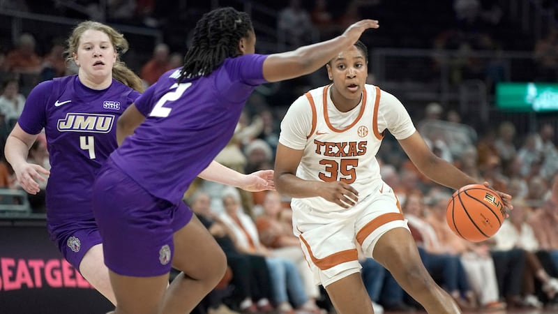 Texas forward Madison Booker works around James Madison guard Delilah Soltys and guard Kylie...