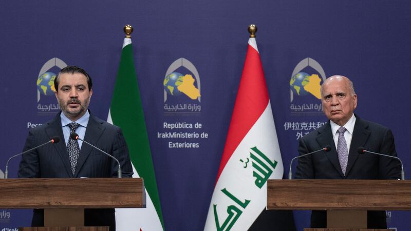 Syrian Foreign Minister Asaad al-Shaybani, left, speaks during a news conference with his...