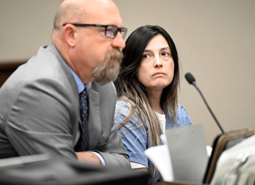 Rebecca Haro sits in court with her defense attorney Jeff Moore inside the Riverside Hall of...